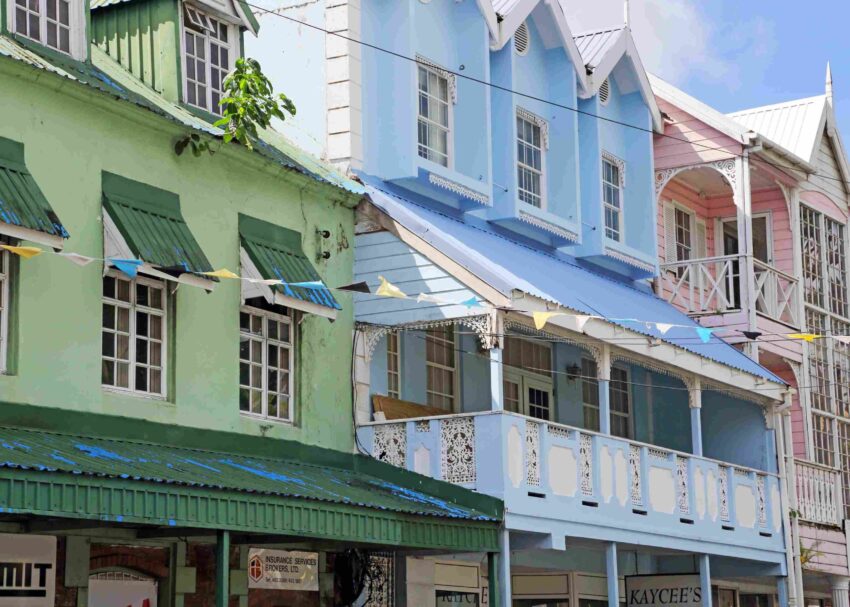 Pastel colored buildings with balconies and decorative architecture in a St. Lucia streetscape