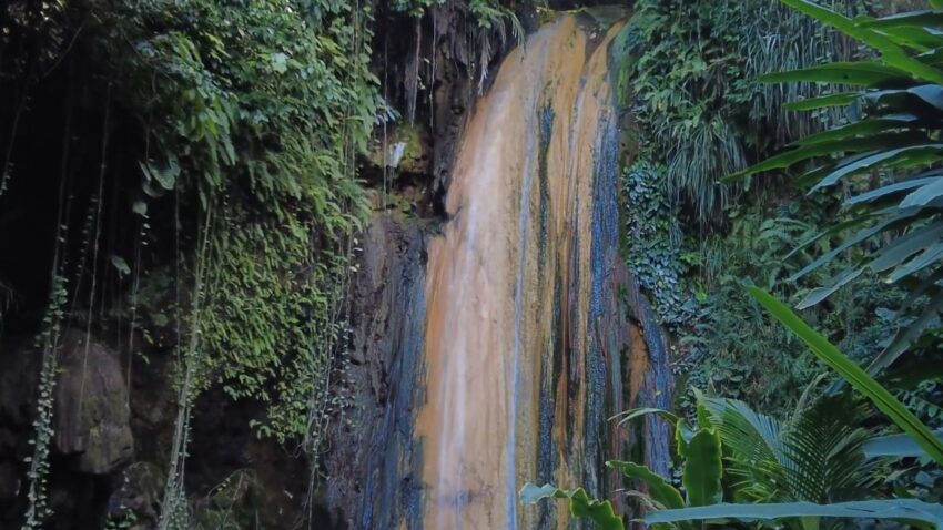 Diamond Falls cascades through lush tropical plants in St. Lucia