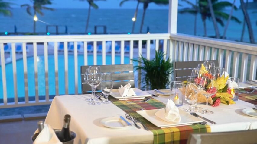 Restaurant table set by the pool and ocean in St. Lucia