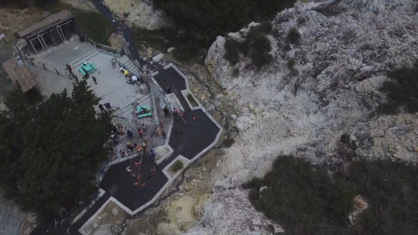 Aerial view of visitors relaxing in the dark mineral pools at Sulphur Springs in St. Lucia