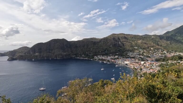 Coastal town and harbor view in St. Lucia with homes along the waterfront