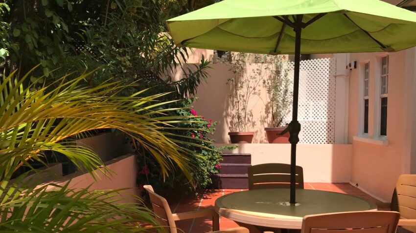 Outdoor patio area at a rental home in St. Lucia surrounded by tropical plants