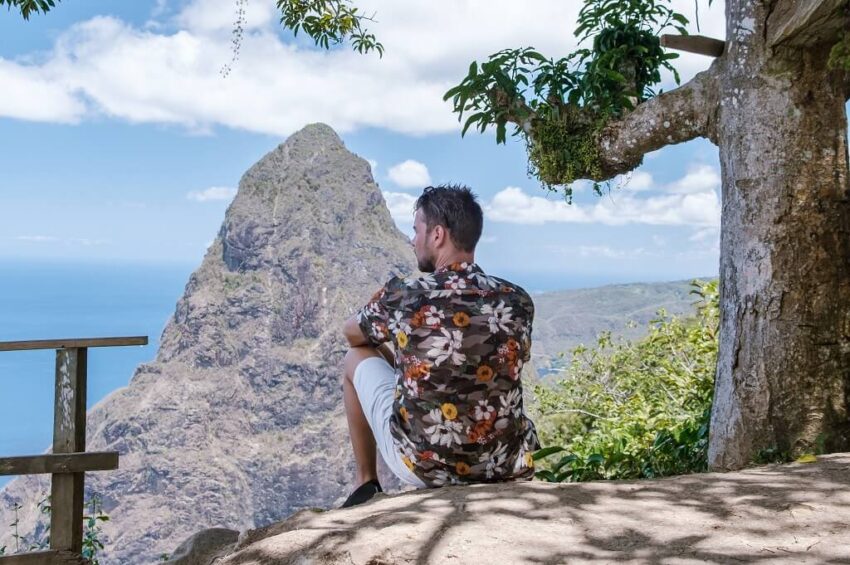 Traveler overlooking Gros Piton from a scenic viewpoint near Soufrière