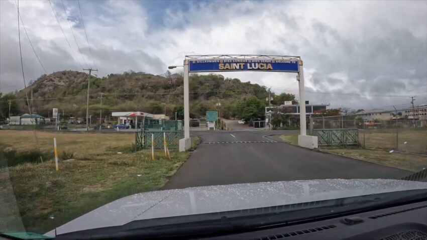 A road passes under a Saint Lucia welcome sign near the airport