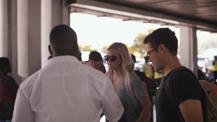 Travelers meet a driver at a St. Lucia airport transfer area