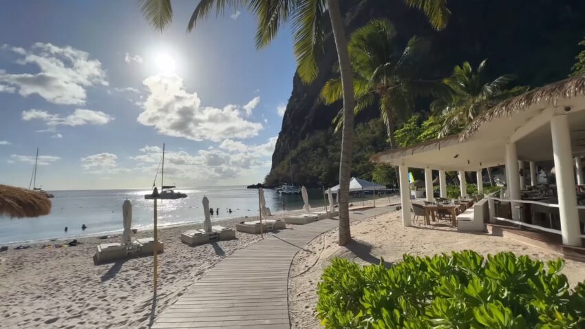 Luxury beach resort in St. Lucia beside palm trees and calm water