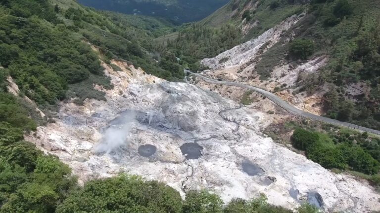 Aerial view of the Volcano in St. Lucia with steam vents, mineral pools, and a road through Sulphur Springs